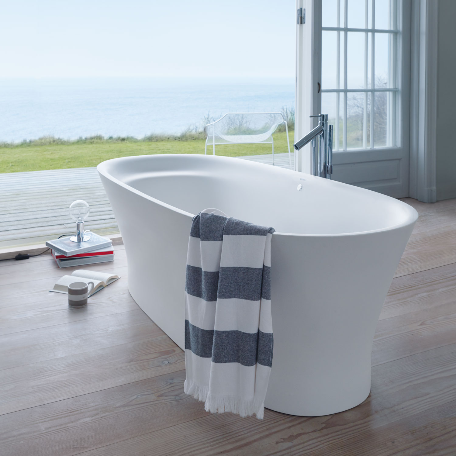 Towel hanging over freestanding Cape Cod bathtub

